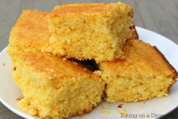 Close up image of cornbread on a white plate. 