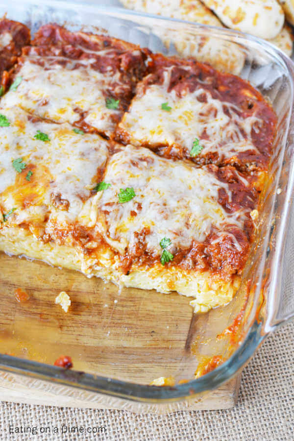 Spaghetti pie in baking dish that is cut and ready to serve.