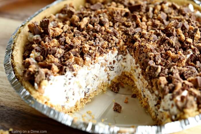 Close up image of a Reese's candy Peanut Butter Pie with a piece gone. 