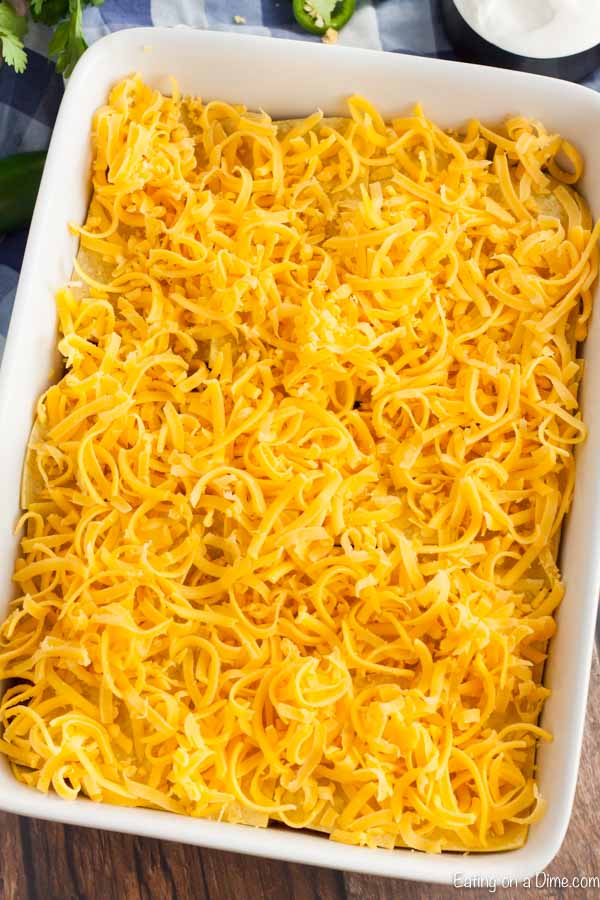 The shredded cheese on top of the casserole in a 9X13 baking pan. 