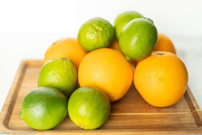 Learn how to freeze lemons and limes either whole or in slices. I love freezing citrus to save to use for juice, zest or for water. How to freeze lemons is easier than you think think! #eatingonadime #freezinglemons #freezingcitrus #freezertips 