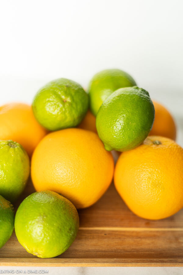 Learn how to freeze lemons and limes either whole or in slices. I love freezing citrus to save to use for juice, zest or for water. How to freeze lemons is easier than you think think! #eatingonadime #freezinglemons #freezingcitrus #freezertips 