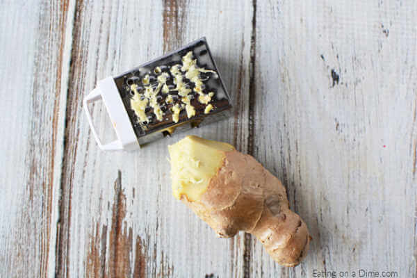 Close up image of fresh ginger with a grater. 
