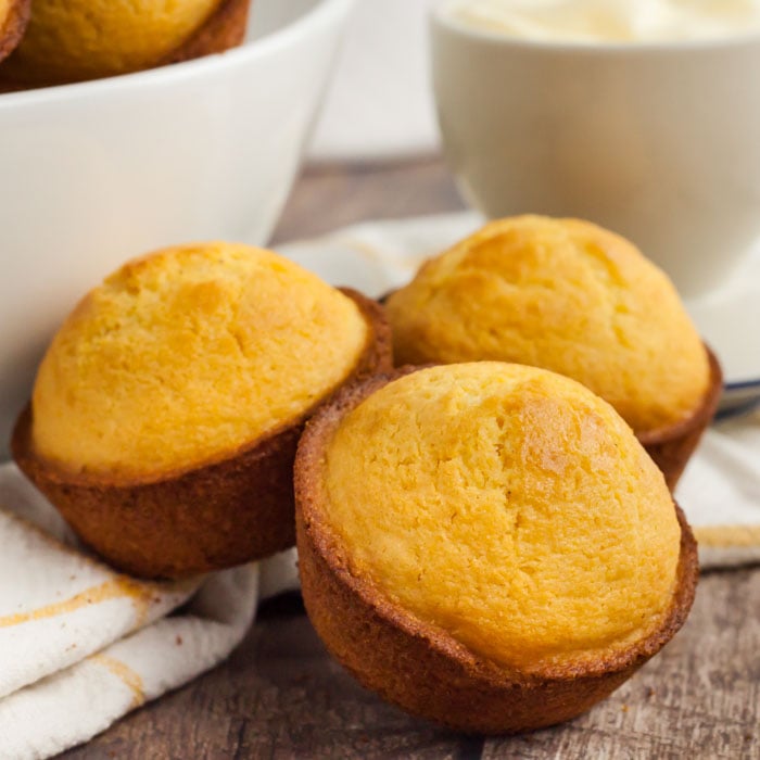 corn muffins sitting on a kitchen towel