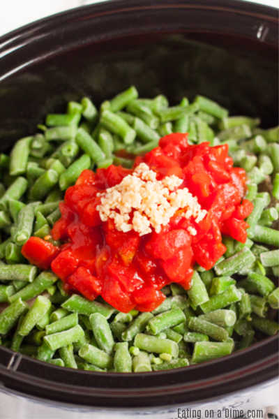 One pot meals are such a time saver around here and this Crock Pot Pork Chop Dinner does not disappoint. Enjoy tender pork, green beans and tomatoes!