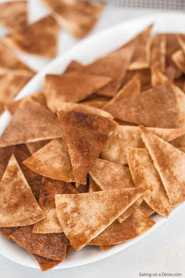 Cinnamon Chips make a delicious and easy dessert or snack idea. With only 4 ingredients, homemade cinnamon chips can be ready in minutes. #eatingonadime #easydessertrecipes #recipestortilla #simpledessertrecipes 