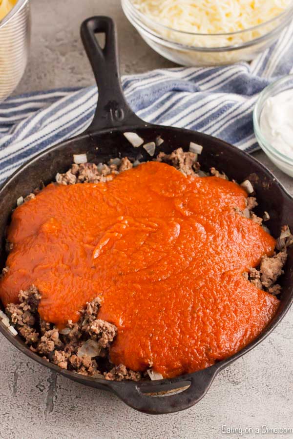 Cook hamburger meat in a cast iron skillet and topped with sauce