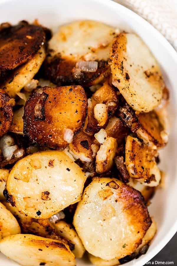 Pan fried potatoes in a white bowl