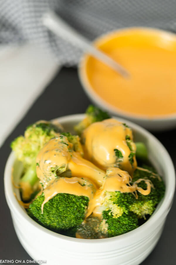 Learn how to make an easy American Cheese Sauce that is low carb with no flour and is perfect for broccoli and for pretzels. This quick and easy cheese sauce is great for fries and for veggies! You are going to love this melted easy cheese sauce for broccoli recipe with only 2 ingredients! #eatingonadime #cheesesaucerecipes #easyrecipes 