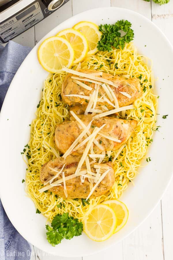 Lemon chicken on spaghetti noodles on a plate