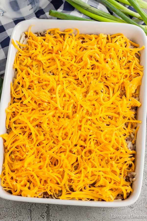 Shredded cheese on top of casserole ready to go in the oven.