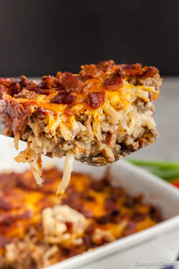 Spatula of cheeseburger casserole being served from baking dish.