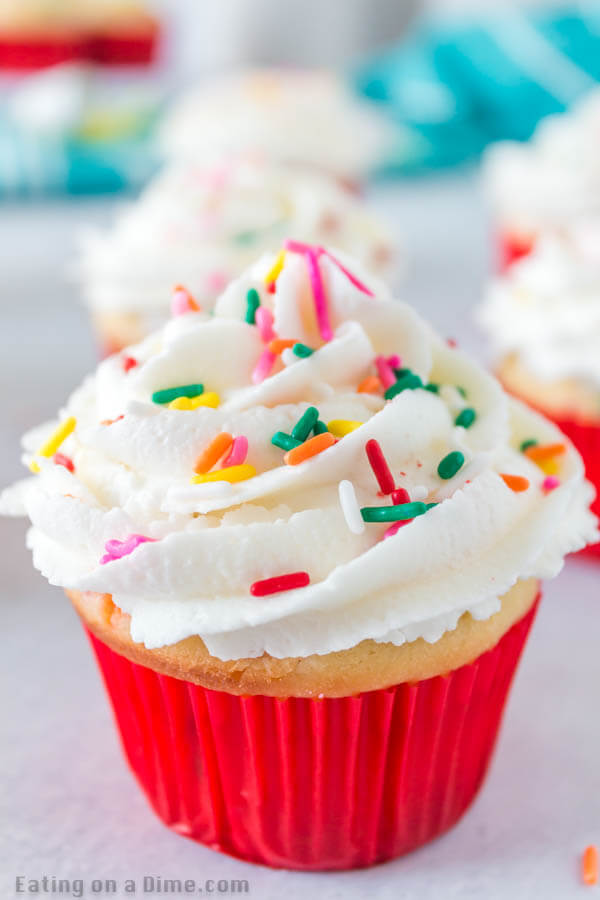 Learn how to make these easy, moist funfetti cupcakes at home with rainbow sprinkles. These easy homemade cupcakes are perfect for any event: Birthday, Christmas or Easter! My kids love funfetti but I can’t always find the cake mix for them, so this is a great option to make homemade, DIY, cute, sprinkle stuffed cupcakes. This is one of my favorite cupcake recipes. This best homemade funfetti cupcake recipe is easy to make and the best home made cupcakes! #eatingonadime #cupcakerecipes #dessertrecipes #funfettidesserts #easyhomemade 