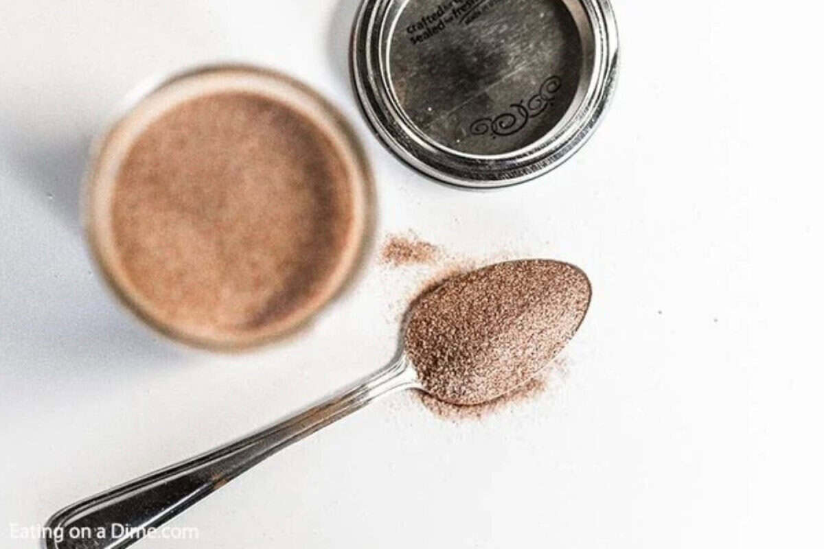 Learn how to make cinnamon sugar at home and save a ton of money. Skip the store bought mixture and make this in minutes. A jar of the mixture with a spoon full next to it.