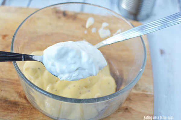 The sour cream sauce being mixed together in a small bowl.  