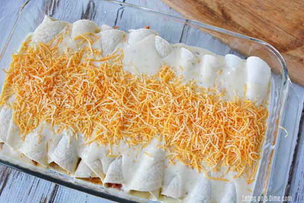 The sour cream sauce poured on top of the enchiladas topped with the shredded cheese.  