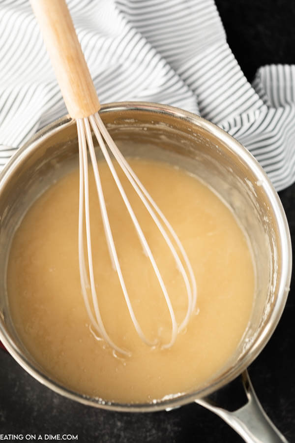 Close up image of roux with a whisk in a pan. 