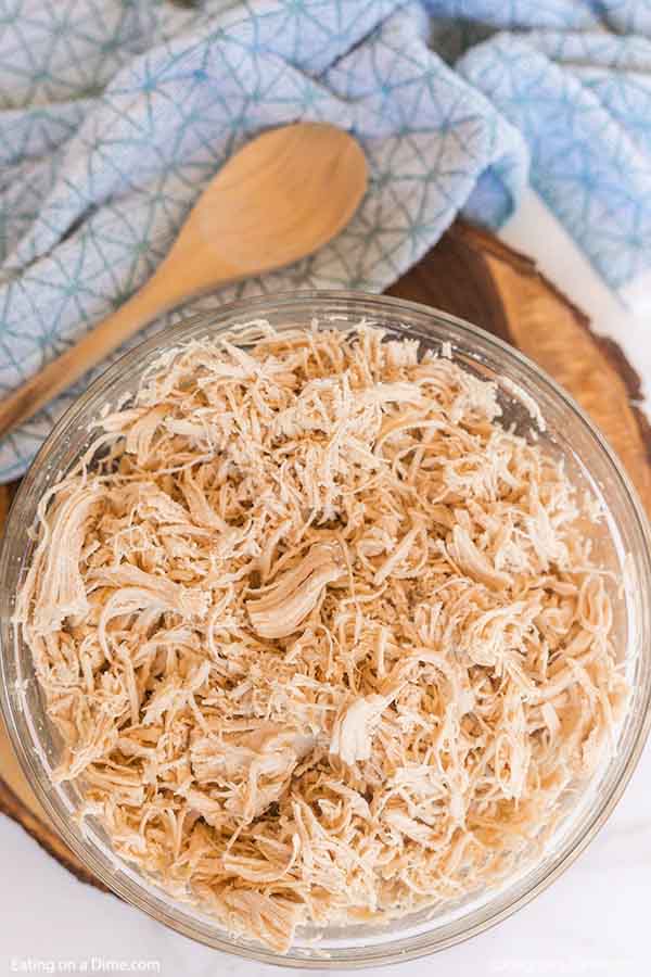 Learn how to shred chicken easily with a KitchenAid Mixer. Save time and shred a ton of meat in just seconds! How to shred chicken breast fast and easy. Once you know how to shred chicken with a mixer, it is so easy. Find out how to shred chicken with hand mixer. #eatingonadime #howtoshredchicken