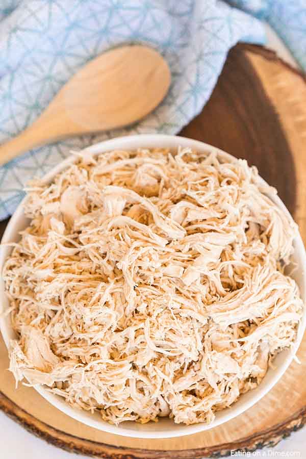 Learn how to shred chicken easily with a KitchenAid Mixer. Save time and shred a ton of meat in just seconds! How to shred chicken breast fast and easy. Once you know how to shred chicken with a mixer, it is so easy. Find out how to shred chicken with hand mixer. #eatingonadime #howtoshredchicken
