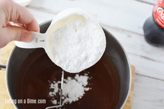 Adding the powdered sugar to the icing mix