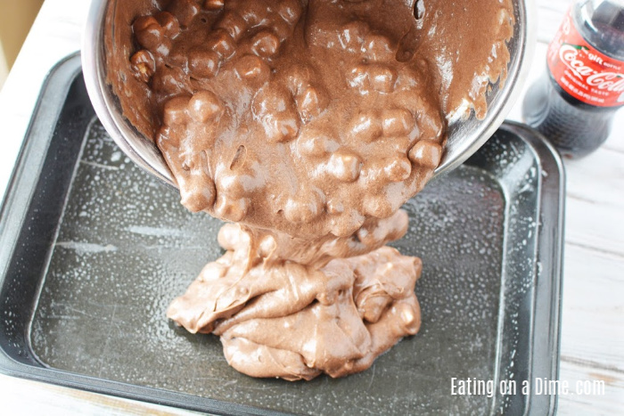 Pouring the chocolate cola cake batter in a cake pan