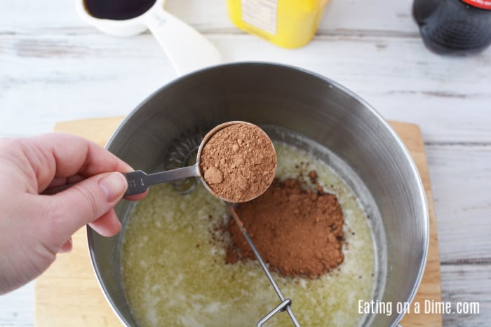 Adding cocoa powder to the melted butter