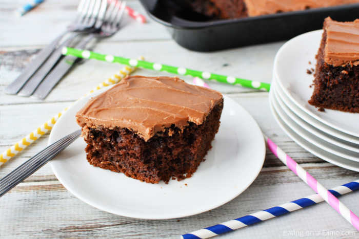 A serving of chocolate cola cake on a white plate