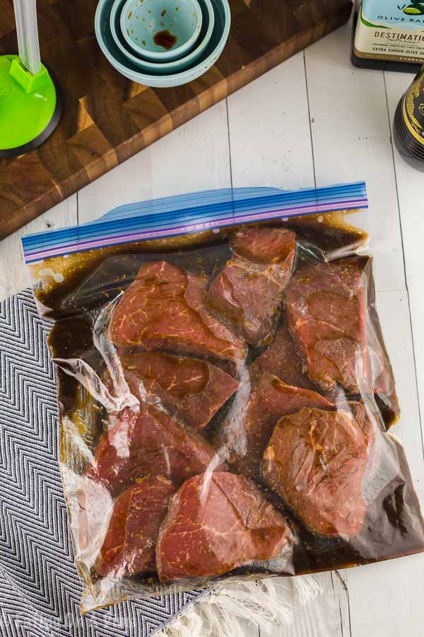 Steaks and marinade sealed in a zip lock bag.  