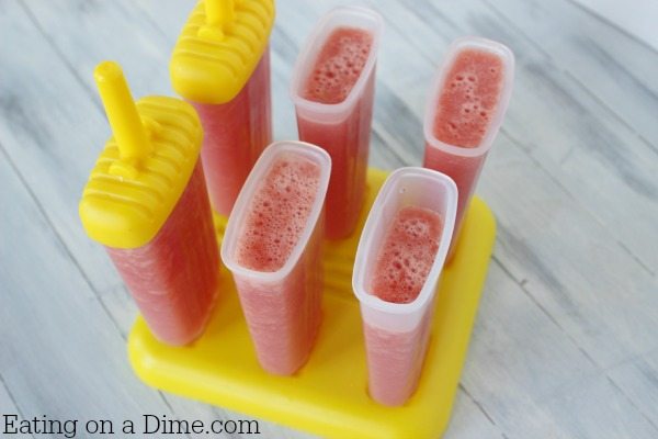 Pouring the watermelon mixture in popsicle molds