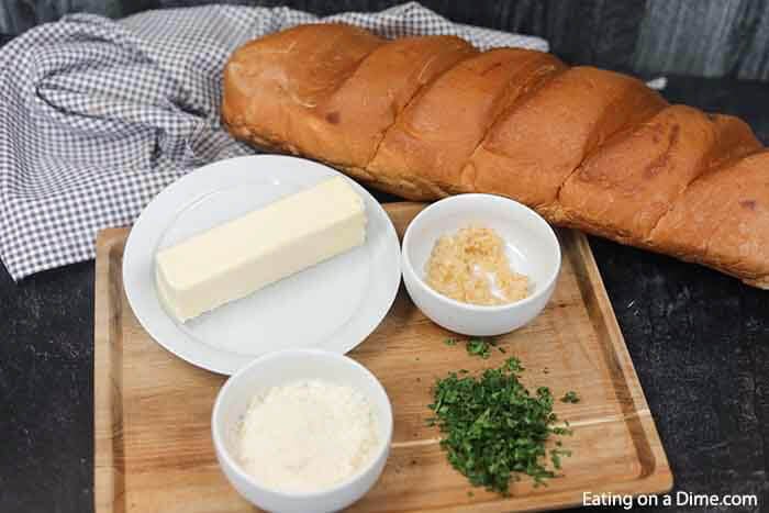 Learn how to make easy homemade cheesy garlic bread. This roasted homemade cheesy garlic bread recipe is the best DIY garlic bread. This home made french bread garlic bread recipe easy is better than Texas toast. Plus learn how to freeze garlic bread. You can make ahead and freeze this simple garlic loaf for later. Make and freezer for a quick and easy Side dish. Can you imagine having homemade garlic bread whenever you want? #eatingonadime #garlicbread #freezebread #freezerrecipes 