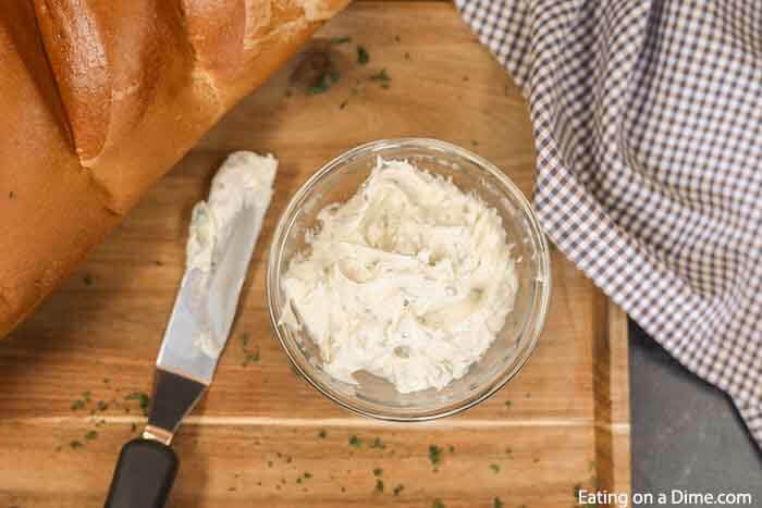 Learn how to make easy homemade cheesy garlic bread. This roasted homemade cheesy garlic bread recipe is the best DIY garlic bread. This home made french bread garlic bread recipe easy is better than Texas toast. Plus learn how to freeze garlic bread. You can make ahead and freeze this simple garlic loaf for later. Make and freezer for a quick and easy Side dish. Can you imagine having homemade garlic bread whenever you want? #eatingonadime #garlicbread #freezebread #freezerrecipes 