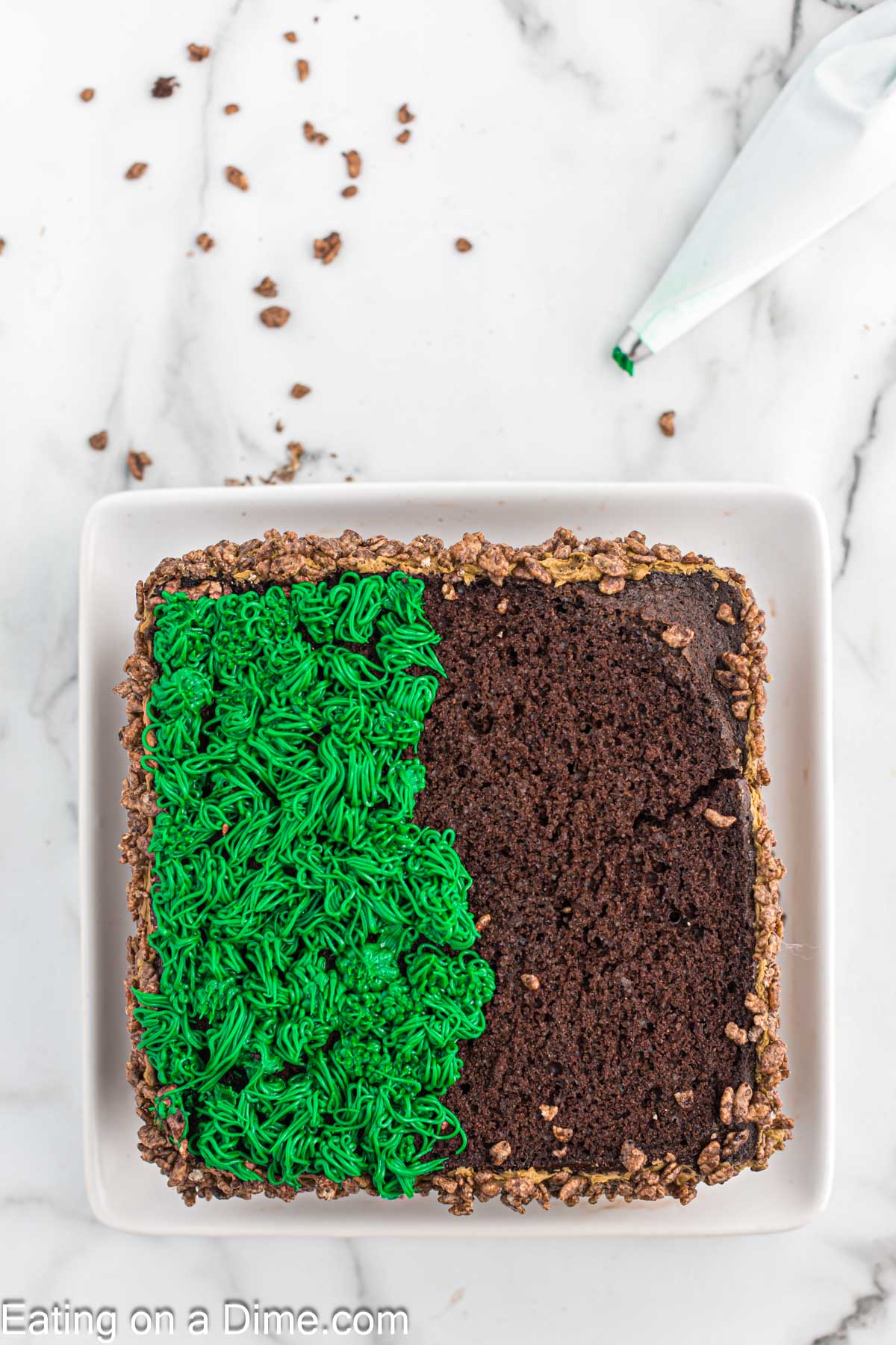 Topping the cake with the green frosting