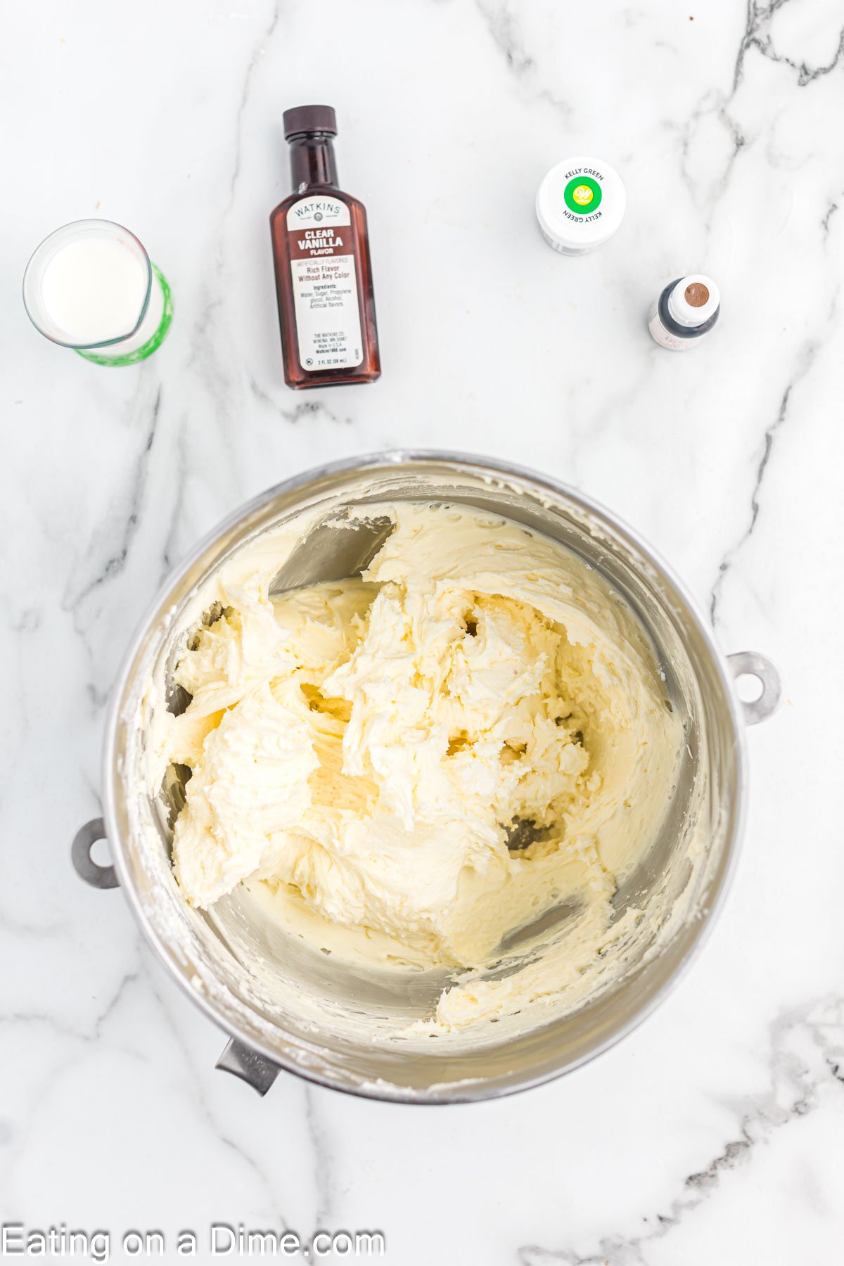 Adding the powdered sugar, milk, and vanilla into the butter