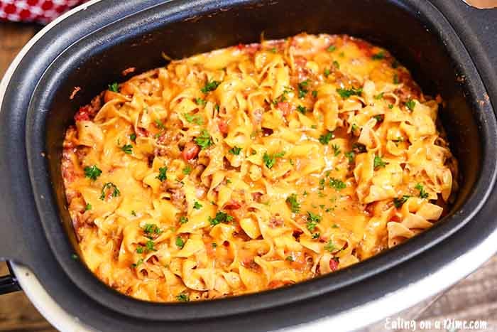 Close image of beef and noodle casserole in a crock pot. 