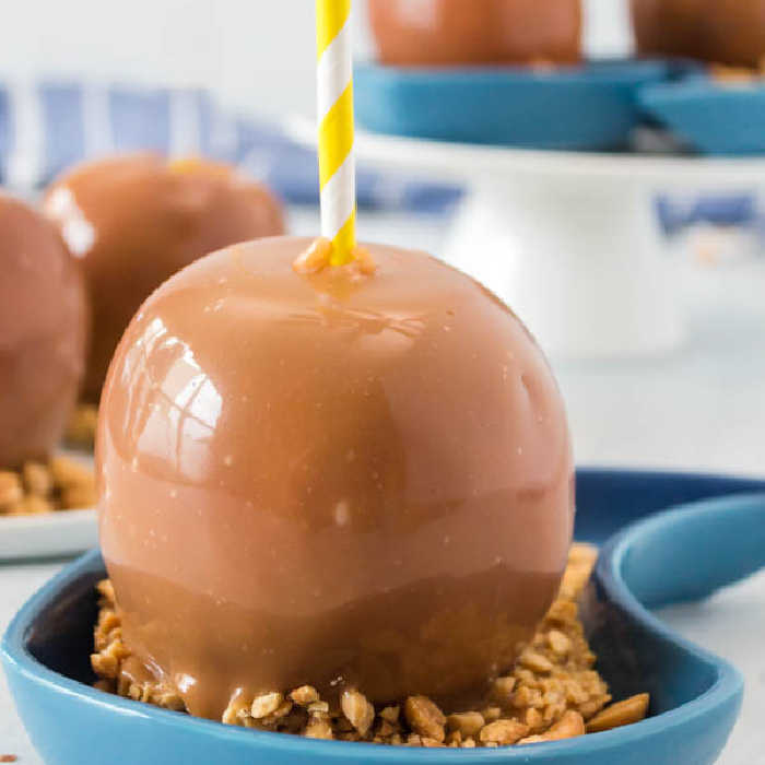 Learn how to make homemade caramel apples. They are so easy to make with a few simple ingredients and you dip each apple. Perfect for your next party or Halloween carnival! This is this best DIY caramel apples recipe. #eatingonadime #applerecipes #caramelapples 