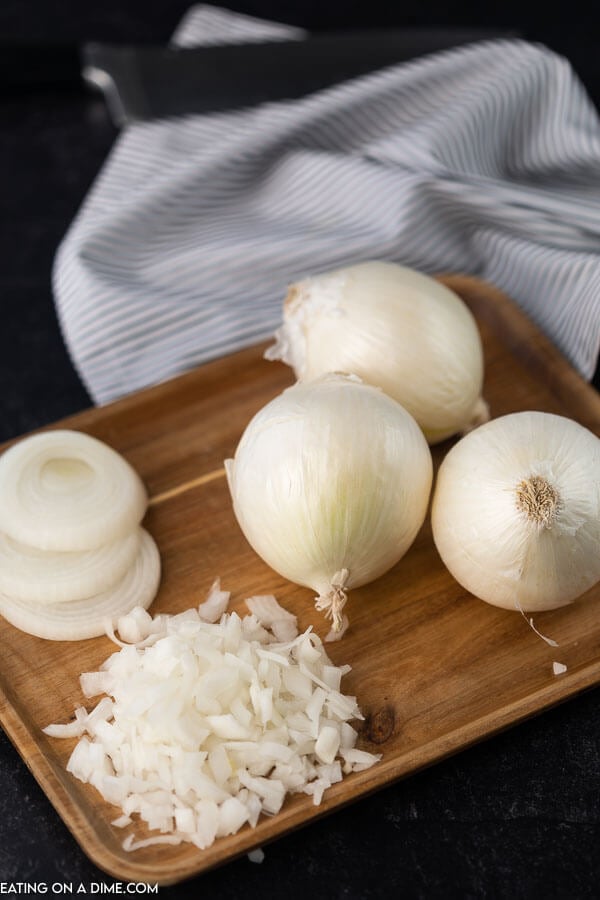 Chopped Onions, Sliced Onions and Whole Onions on a Cutting Board