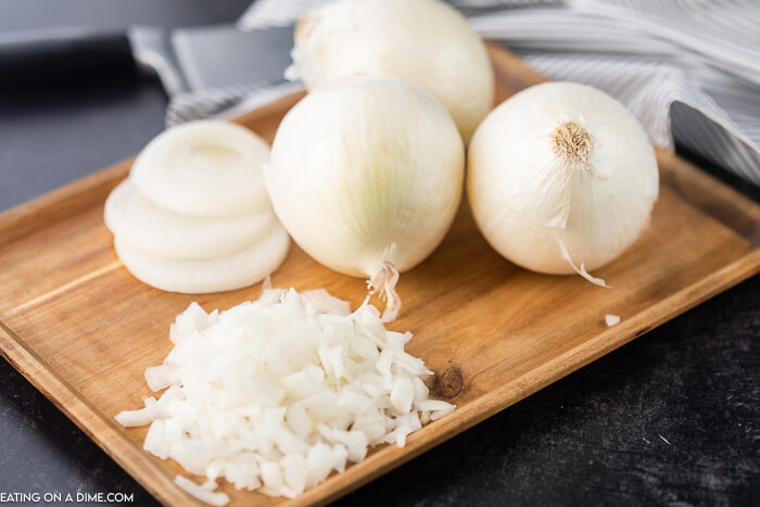 Chopped Onions, Sliced Onions and Whole Onions on a Cutting Board