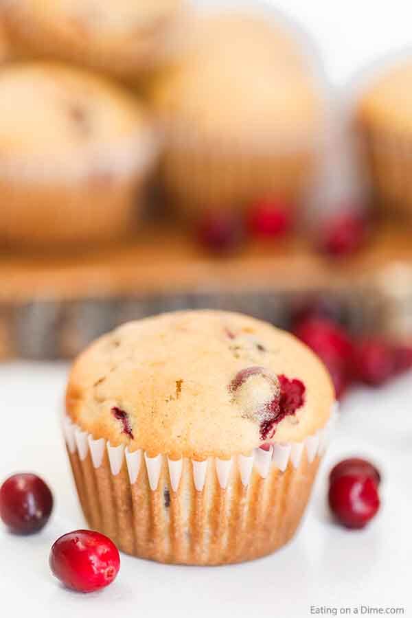 Try this easy and delicious Easy Cranberry Muffins Recipe next time you grab fresh cranberries on sale. These easy orange cranberry muffins are perfect for a breakfast or a snack around the holidays. This is the best healthy, homemade, moist orange cranberry muffins recipes easy. Everyone in the family will love these best orange cranberry muffins. #eatingonadime #cranberrymuffins #muffinrecipes #breakfastrecipes 