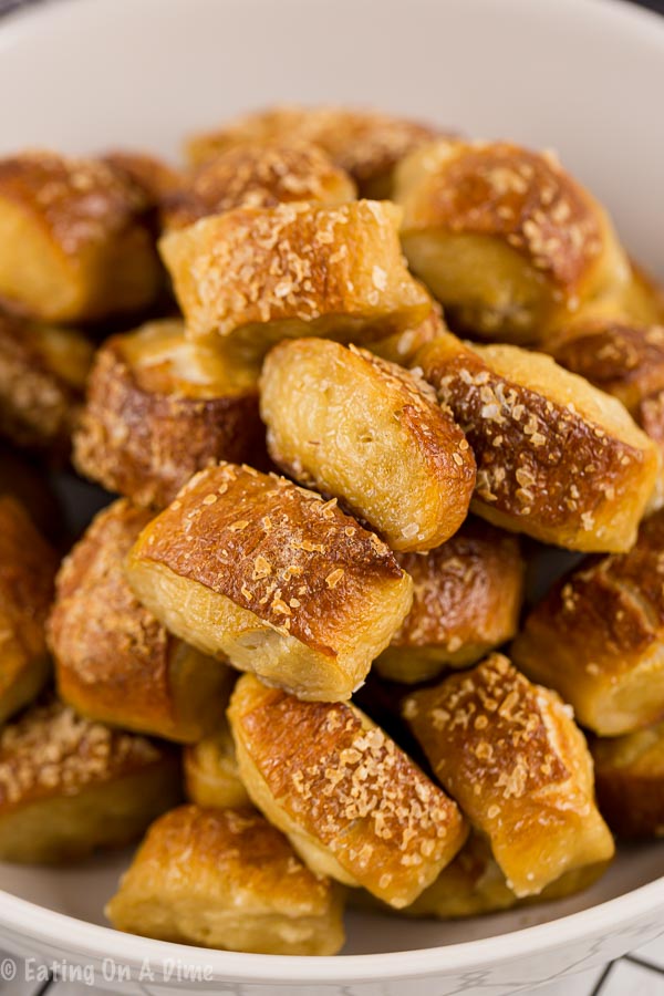 Close up image of pretzel bites in a white bowl. 