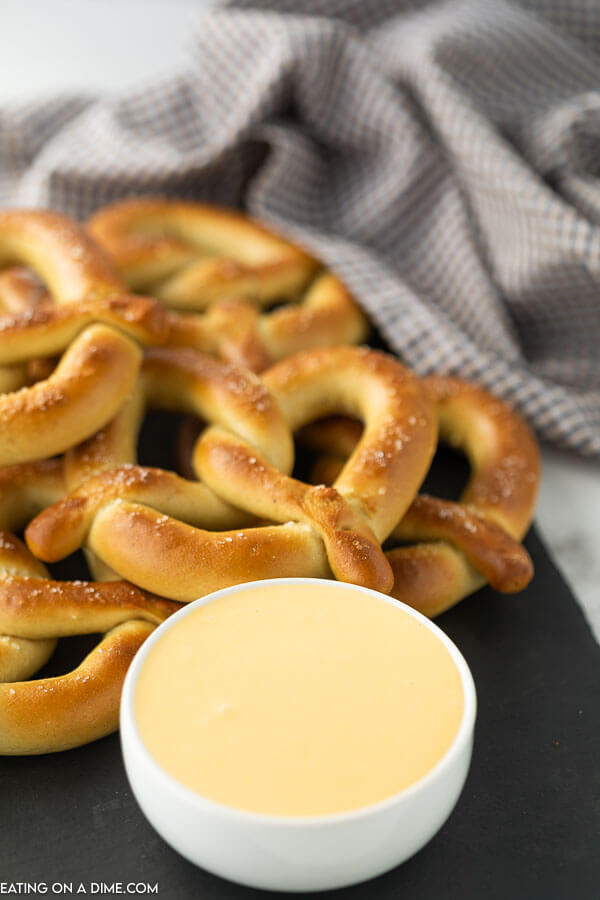 stack of pretzels and a bowl of cheese sauce