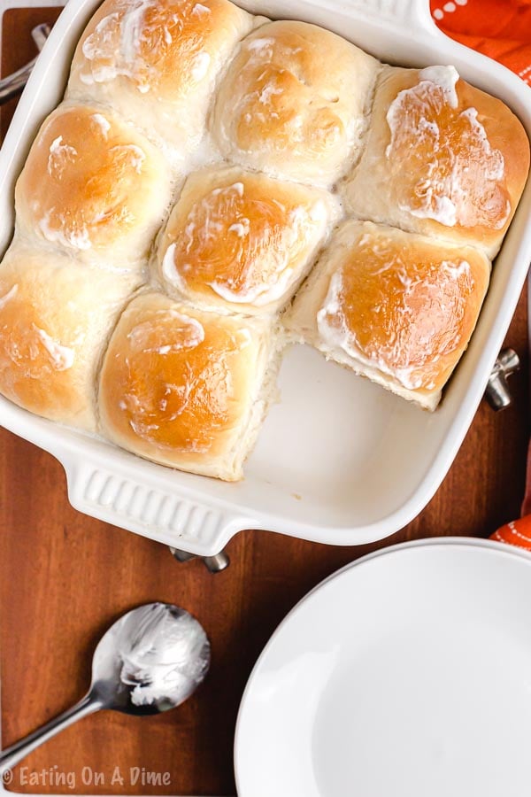 Close up image of hawaiian rolls in a pan with butter. 