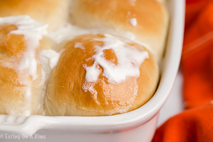 close up image of hawaiian rolls in a pan with butter. 