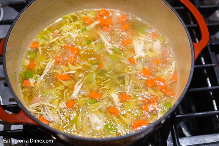 The chicken, water, broth and seasoning added to a stock pot. 