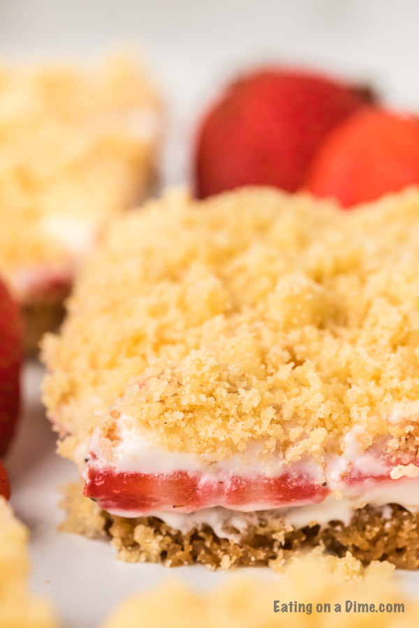 These strawberry crunch bars are easy to make and very delicious! This no bake strawberry crunch bars recipe with cookies is perfect for any occasion. These strawberry cookie bars are simple to make. You are going to love these strawberry crumb bars! #eatingonadime #easydesserts #strawberrydesserts 