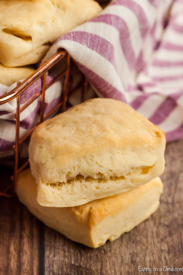 Close up image of two biscuits next to a wired basket with a hand towel. 