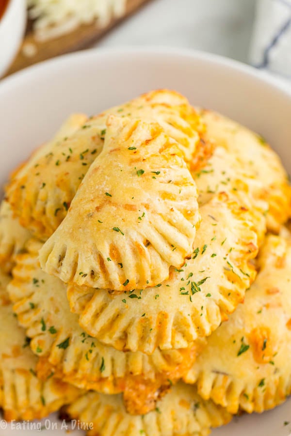 Pizza pockets stacked in a bowl
