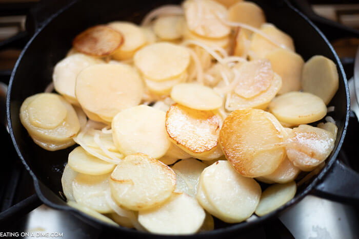 Potatoes and Onion being browned in a large cast iron skillet