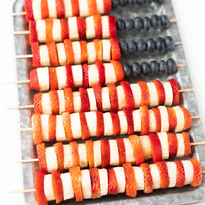 Closeup photo of red, white and blue fruit kabobs made into a flag. 