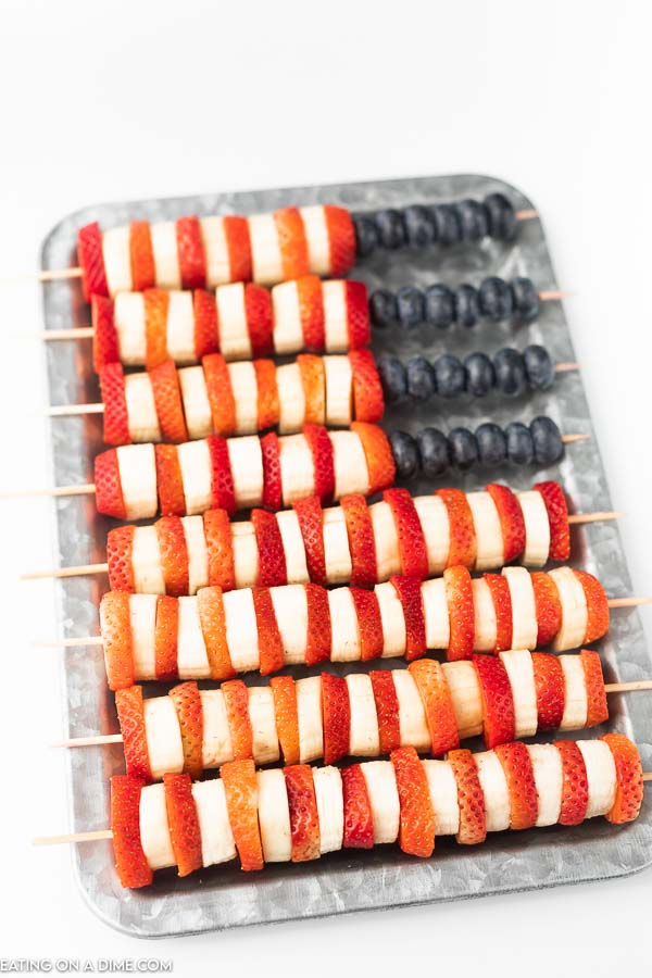 Photo of platter with red, white and blue fruit kabobs.