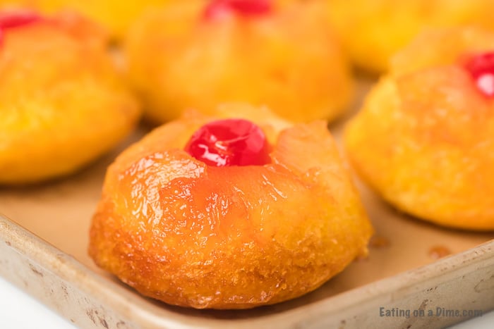 Close up image of pineapple upside cake on a cookie sheet. 